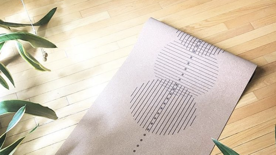 Revolve cork yoga mat on wood floor with plant