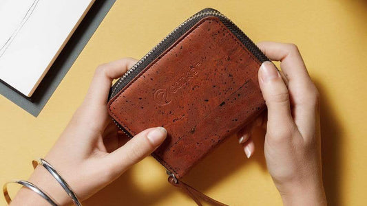 Hands holding a Corkor vegan leather cork wallet in red